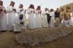 Family members of Saudi Crown Prince Sultan bin Abdulaziz perform final prayers at his grave at Al Oud cemetery in Riyadh